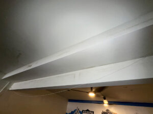 Newport Beach Luxury Home Sewage Backup Mold Inspection 5 Ceiling With Visible Mold And Exposed Wires Hanging Down, Indicating Potential Maintenance Issues.